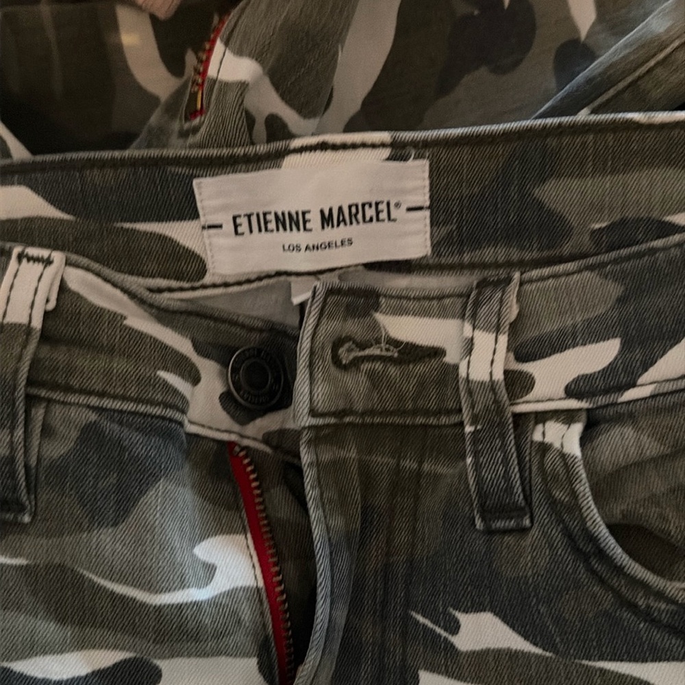 Camo skinny jeans with ankle zippers and red seems